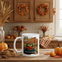 Load image into Gallery viewer, White mug with 'Fall Harvest' design in a kitchen setting with pumpkins and wreaths.