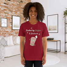 Load image into Gallery viewer, Woman wearing a red t-shirt with a coffee-themed design in a living room.