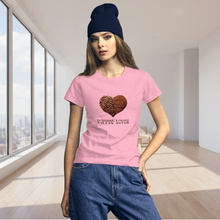 Load image into Gallery viewer, Woman modeling womens fitted pink t-shirt with image phrase coffee lover in brown font, with image graphic of a heart shape half filled with whole coffee beans, half filled with ground coffee