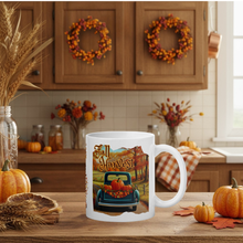 Load image into Gallery viewer, White mug with 'Fall Harvest' design in a kitchen setting with pumpkins and wreaths.