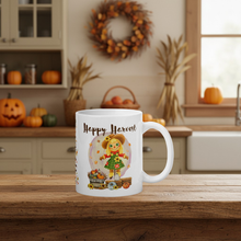 Load image into Gallery viewer, White mug with 'Happy Harvest' design on a wooden table in a kitchen setting.