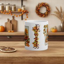 Load image into Gallery viewer, White mug with autumn-themed design on a wooden table with fall decorations in the background.