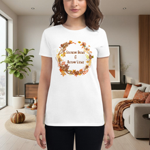 Load image into Gallery viewer, Person wearing a white t-shirt with autumn-themed design in a living room.