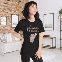 Load image into Gallery viewer, Woman wearing a black t-shirt with a coffee-themed design in a living room.