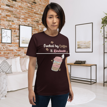 Load image into Gallery viewer, Person wearing a brown t-shirt with a coffee-themed design in a modern living room.
