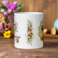 Load image into Gallery viewer, Back side view of a white glossy mug with a beautiful floral arrangement featuring pink, white, and purple flowers with golden sparkles on a light blue background.