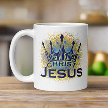 Load image into Gallery viewer, Right side view of the white glossy mug featuring the phrase "King of Kings, Christ, Jesus" with golden and blue sparkles in the background.