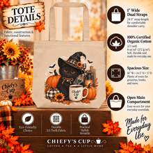 Load image into Gallery viewer, A tote bag featuring a black cat in a witch hat surrounded by pumpkins and autumn decorations, shown with informational text callouts and decorative fall leaves. The tote has printed text reading 'Chiefy's Cup' on the mug area and 'Chiefy's Cup Coffee Tea A Little More' at the bottom.