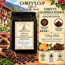 Load image into Gallery viewer, A bag of Chiefy's Cup Coffee Co. Colombian Reserve ground coffee is shown against a rustic coffee-themed background with beans, oranges, flowers, and informational text about medium roast, tasting notes, and serving suggestions.