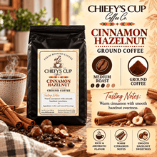 Load image into Gallery viewer, A bag of Chiefy's Cup Coffee Co. Cinnamon Hazelnut Ground Coffee is shown on a rustic wooden table with cinnamon sticks, hazelnuts, and a steaming mug.