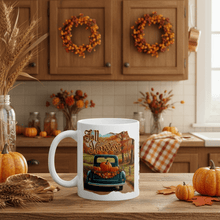 Load image into Gallery viewer, White mug with 'Fall Harvest' design in a kitchen setting with pumpkins and wreaths.
