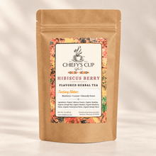Load image into Gallery viewer, A stand-up kraft paper pouch of Chiefy's Cup Coffee Co. Hibiscus Berry Flavored Herbal Tea, featuring a colorful label with a floral border and product details, set against a warm beige background with soft shadows.