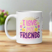 Load image into Gallery viewer, Left side view of a white glossy mug with the phrase “I Love My Friends” in pastel pink and blue letters, accompanied by a playful word “woof” , yellow, pink flowers and a yellow circle background.