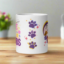 Load image into Gallery viewer, Back side view of a white glossy mug with colorful paw prints in blue, pink, and purple, surrounded by golden sparkles.