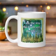 Load image into Gallery viewer, Left side view of a white glossy mug featuring the phrase "I am the way, the truth, and the life" with the Bible verse John 14:6, accompanied by a starry sky, glowing pine trees, golden lights, and translucent butterflies.
