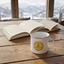 Load image into Gallery viewer, Chiefy's Cup Heritage Gold enamel mug on a rustic wooden table beside open books