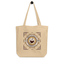 Load image into Gallery viewer, A beige canvas tote bag with two shoulder straps, featuring a circular coffee-themed graphic on the front that reads 'Chiefy's Cup Coffee Co' and 'Premium Coffee' with 'Est. 2020'.