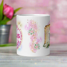 Load image into Gallery viewer, Back side view white glossy mug with image design of pink and white lilies, with golden sparkles flowing, translucent butterflies, and golden bright sparkles with pink hues in the background.