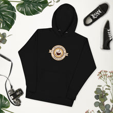 Load image into Gallery viewer, Black hoodie with 'Chiefy's Cup Coffee Co' logo on a white background with plants and shoes.