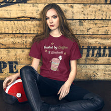Load image into Gallery viewer, Person wearing a maroon t-shirt with a coffee-themed design in a modern living room.