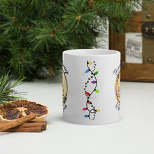 Load image into Gallery viewer, Back side view of a white glossy mug featuring a string of Christmas lights, a trail of kitten pawprints, and small colorful sparkles.