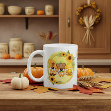 Load image into Gallery viewer, Left side view of a white glossy mug featuring a design of festive fall gnomes holding Thanksgiving desserts, encircled by a sunflower wreath on a yellowish-green background.
