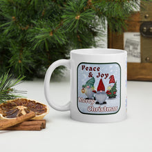 Load image into Gallery viewer, Left side view of a white glossy mug with the phrase "Peace and Joy Merry Christmas" in festive font, featuring a Christmas gnome design with a snowy blue background.