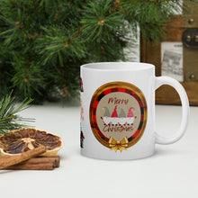 Load image into Gallery viewer, Right side view of a white glossy mug with the phrase "Merry Christmas" in festive font, featuring Christmas gnomes dressed in red plaid with a golden bow and a wooden circle background.