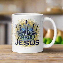 Load image into Gallery viewer, Left side of a white glossy mug featuring the phrase "King of Kings, Christ, Jesus" with golden and blue sparkles in the background.
