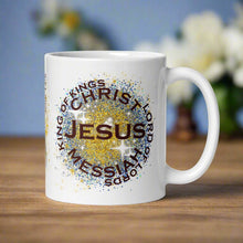 Load image into Gallery viewer, Right side view of a white glossy mug featuring the phrase "King of Kings, Lord of Lords, Messiah, Christ, Jesus," with golden and blue sparkles in the background.
