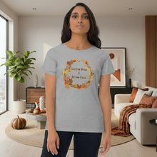 Load image into Gallery viewer, Person wearing a grey t-shirt with autumn-themed design in a living room.