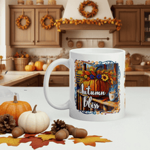 Load image into Gallery viewer, White mug with &#39;Autumn Bliss&#39; design in a kitchen setting with pumpkins and leaves.
