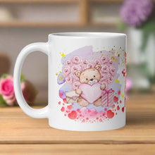 Load image into Gallery viewer, Left side view of a white glossy mug featuring a watercolor teddy bear holding a pink heart, with a floral heart behind it, surrounded by pink and golden accents, a purple splat in the background, and pink hearts around the teddy bear.
