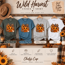 Load image into Gallery viewer, A promotional graphic for a unisex T-shirt collection titled 'Wild Harvest' by Chiefy's Cup. Four T-shirts are displayed on hangers against a rustic wood backdrop: heather forest green, heather deep teal, athletic heather gray, and white.
