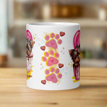 Load image into Gallery viewer, Back view white glossy mug featuring pink and yellow paw prints, small hearts, and chocolates with golden sparkles in the background.
