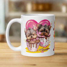 Load image into Gallery viewer, Left side view white glossy mug featuring cute watercolor puppies sitting in a mug of chocolate with golden sparkles behind them, a pink heart in the background, yellow hues, and candy and chocolates scattered around.
