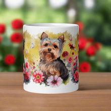 Load image into Gallery viewer, Back side view of a white glossy mug featuring a Yorkie puppy sitting among colorful flowers with a yellow background and butterflies completing the scene.
