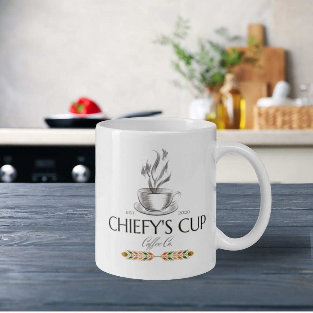 Right side view of white glossy mug featuring the Chiefy’s Cup logo with the image phrase 