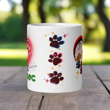 Load image into Gallery viewer, Back side view of a white glossy mug with one pink, one blue, and one purple paw print, surrounded by golden sparkles.
