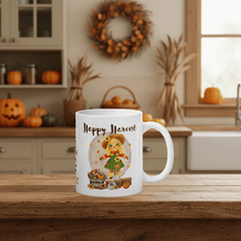 Load image into Gallery viewer, White mug with &#39;Happy Harvest&#39; design on a wooden table in a kitchen setting.
