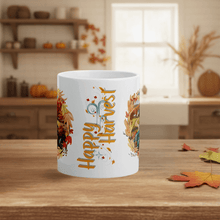 Load image into Gallery viewer, White mug with &#39;Happy Harvest&#39; design on a wooden table with autumn leaves.
