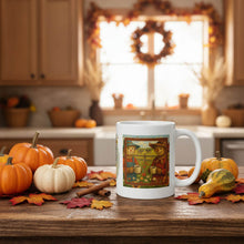 Load image into Gallery viewer, White mug with a colorful design on a kitchen counter with pumpkins and autumn decorations.

