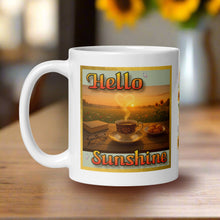 Load image into Gallery viewer, Left side view of a white glossy mug featuring the phrase &quot;Hello Sunshine,&quot; with sunflowers, a tabletop scene including a cup of coffee, a book, and a plate of desserts, set against a glowing sunrise background. Steam rises from the coffee in the shape of a heart.
