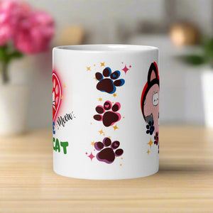 Back side view of a white glossy mug with a design of one pink, one blue, and one purple paw print surrounded by golden sparkles.