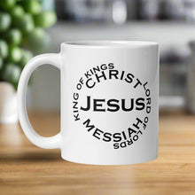 Load image into Gallery viewer, Left side view of a white glossy mug with the phrase &quot;King of Kings, Lord of Lords, Messiah, Christ, Jesus.&quot;
