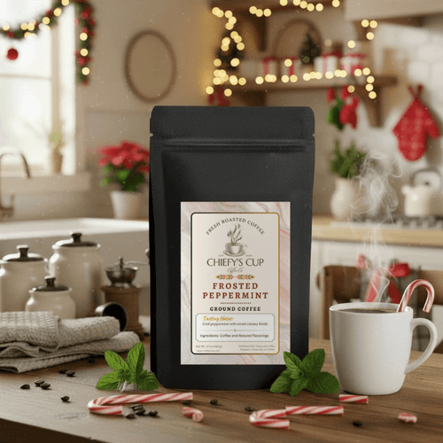 Black coffee bag labeled ‘Chiefy’s Cup Frosted Peppermint Coffee’ on a winter-themed table with scattered coffee beans, candy canes, and a steaming cup of coffee surrounded by spearmint leaves