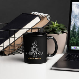 Left side viewof black glossy mug featuring the Chiefy’s Cup logo with a white cup and saucer, white steam rising from the cup, and the phrase "Chiefy’s Cup."