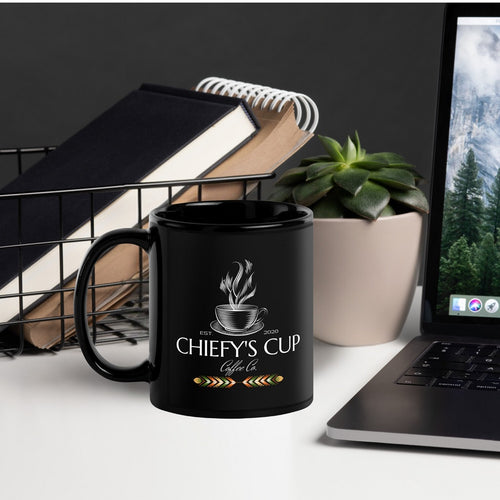 Right side view of black glossy mug featuring the Chiefy’s Cup logo with a white cup and saucer, white steam rising from the cup, and the phrase 