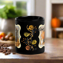 Load image into Gallery viewer, Back side view of a black glossy mug showcasing a design with colorful tumbleweeds, cowboy rope, golden horseshoes, fall leaves blowing, small white bird tracks, and delicate dandelions.
