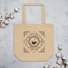 Load image into Gallery viewer, A beige canvas tote bag with a printed circular coffee logo reading 'Chiefy's Cup Coffee Co' and 'Premium Coffee' with 'Est. 2020', photographed flat on a light marble surface with cotton bolls around it.
